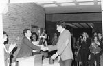 Someone receives their athletic award, circa 1980s by Clark University