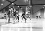 Action shot of men's basketball game [4], circa 1984-1986 by Clark University