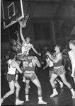 Action shot of men's basketball game [13], 1955 by Clark University
