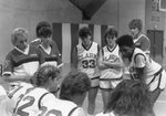 Women's basketball team during a huddle, 1987 by Clark University