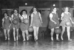 Women’s basketball team dribble the ball, circa 1940s-1950s by Clark University