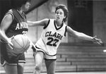 Women’s basketball team member plays defense, circa 1980s by Clark University and Betty Jenewin