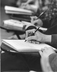 Close-up of students taking notes during class, unknown date by Clark University
