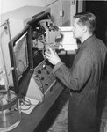 Student uses a laboratory machine, unknown date by Clark University