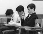 Three students during class, date unknown by Clark University
