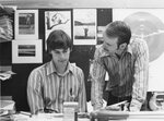 Two people converse in a classroom, circa 1970s by Clark University