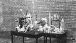 Chemistry materials sit on tables outdoors, date unknown by Clark University