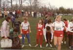 Women’s cross country team members prepare at a meet, circa 1980s by Clark University