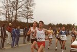 Men’s cross country team member and competitors run at meet, 1986 by Clark University and Mitch Cohen