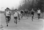 Men’s cross country team members and competitors run at meet, circa 1970s-1980s by Clark University