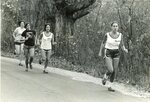 Two women’s cross country members run in meet, circa 1970s-1980s by Clark University