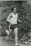 Men’s cross country team member runs in meet, circa 1970s-1980s by Clark University