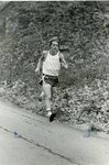 Men’s cross country team member runs in meet [2], circa 1970s-1980s by Clark University