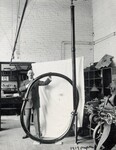 [003] R.H Goddard with circular vacuum tube used to prove rocket efficiency greater in vacuum than in air, 1916 by Unknown