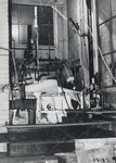 [016] Inside sheet iron shelter at Clark University, first test of liquid propelled rocket lifting its own weight, December 6, 1925 by Esther C. Goddard